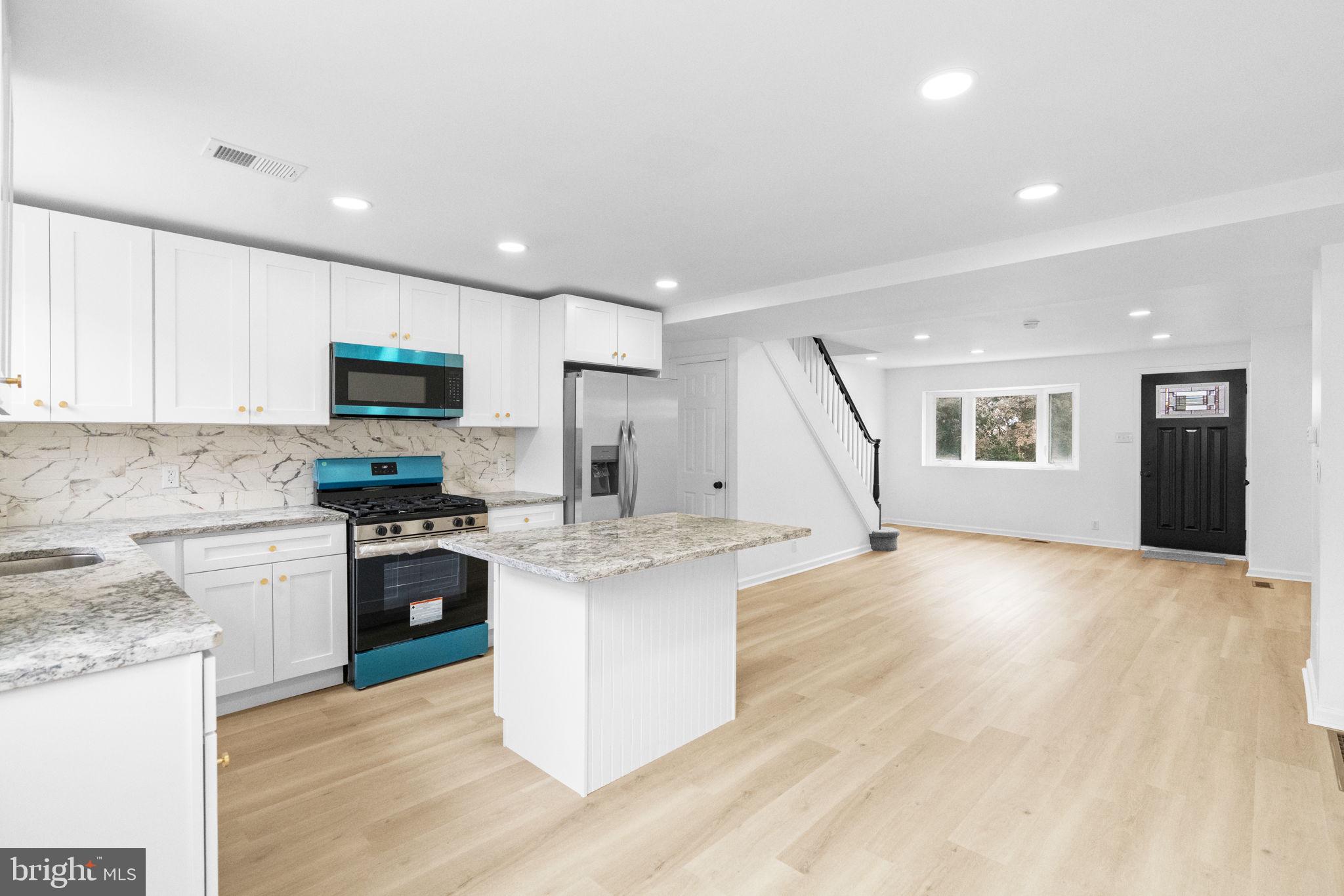 7703 Gilbert Street Philadelphia, PA 19150 - Photo 8 of 37 a kitchen with a sink appliances and cabinets