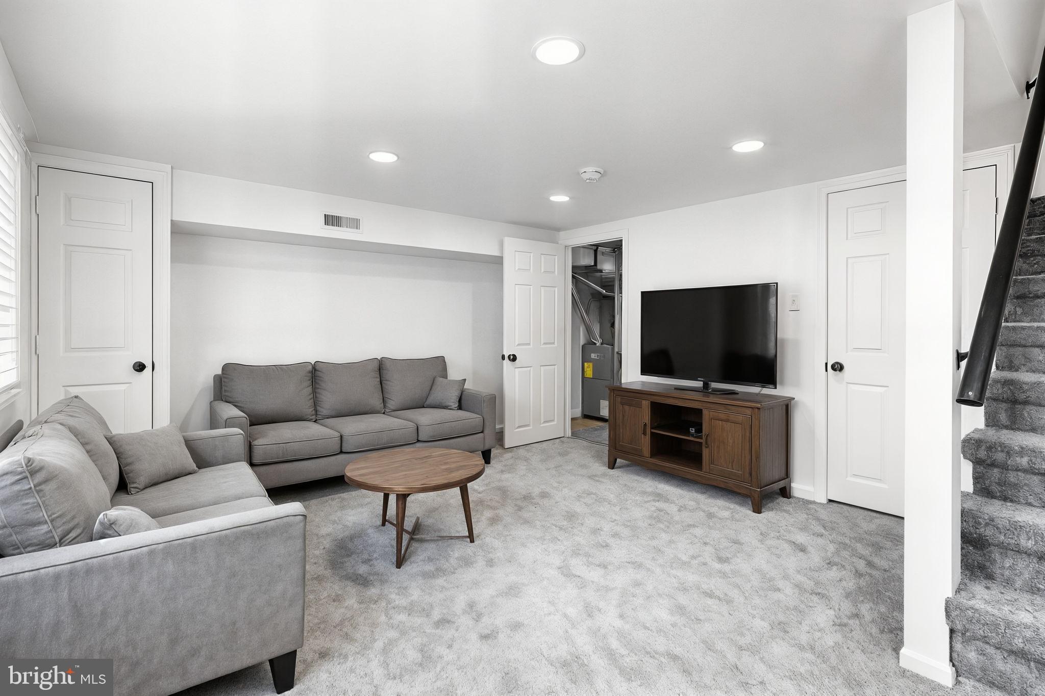 7703 Gilbert Street Philadelphia, PA 19150 - Photo 10 of 37 a living room with furniture and a flat screen tv