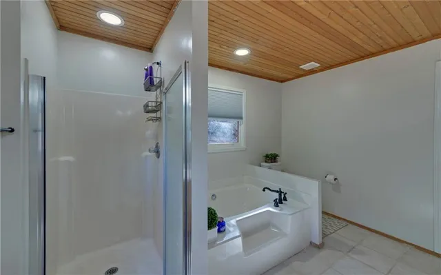 a bathroom with a tub and shower