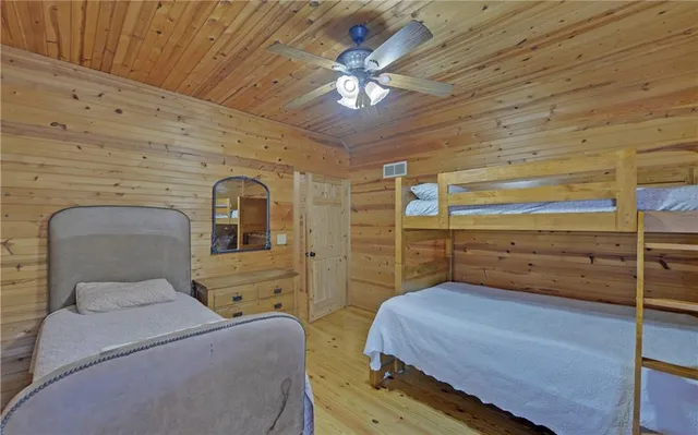 a bedroom with a bed and ceiling fan