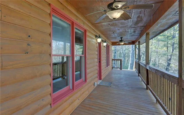 a view of a porch with wooden floor and fence