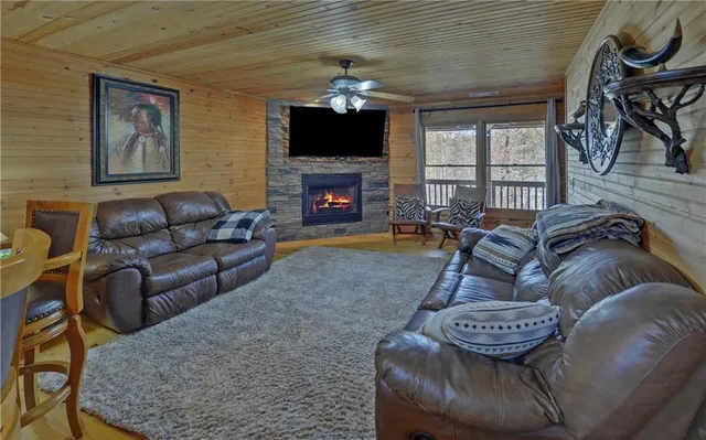 a living room with furniture a fireplace and a flat screen tv