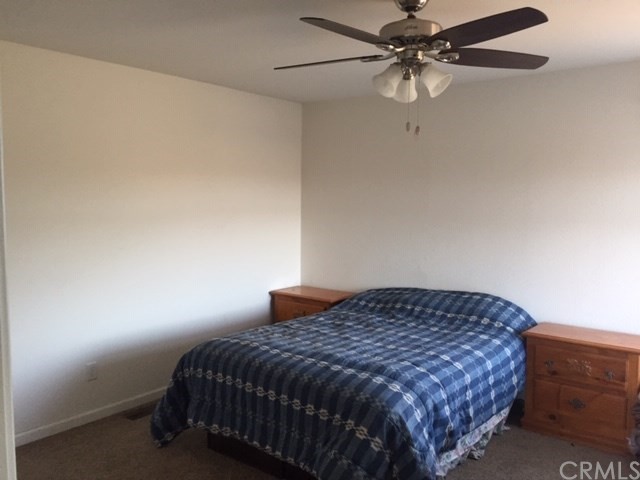 25432 Jerusalem Grde Lower Lake, CA 95457 - Photo 18 of 27 a bedroom with a bed and a ceiling fan