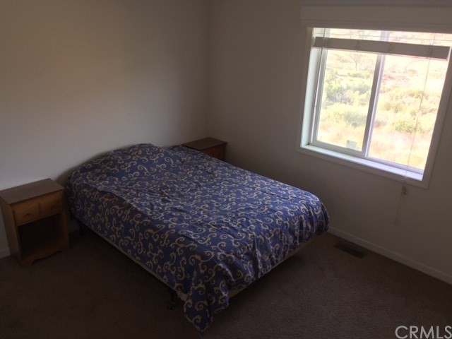 25432 Jerusalem Grde Lower Lake, CA 95457 - Photo 21 of 27 a bed sitting in a bedroom next to a window