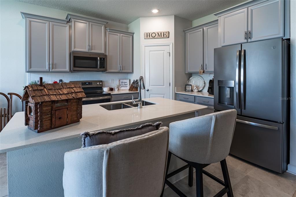 9224 Southwest 60th Ct Road Ocala, FL 34476 - Photo 7 of 55 a kitchen with stainless steel appliances granite countertop a refrigerator stove microwave and sink
