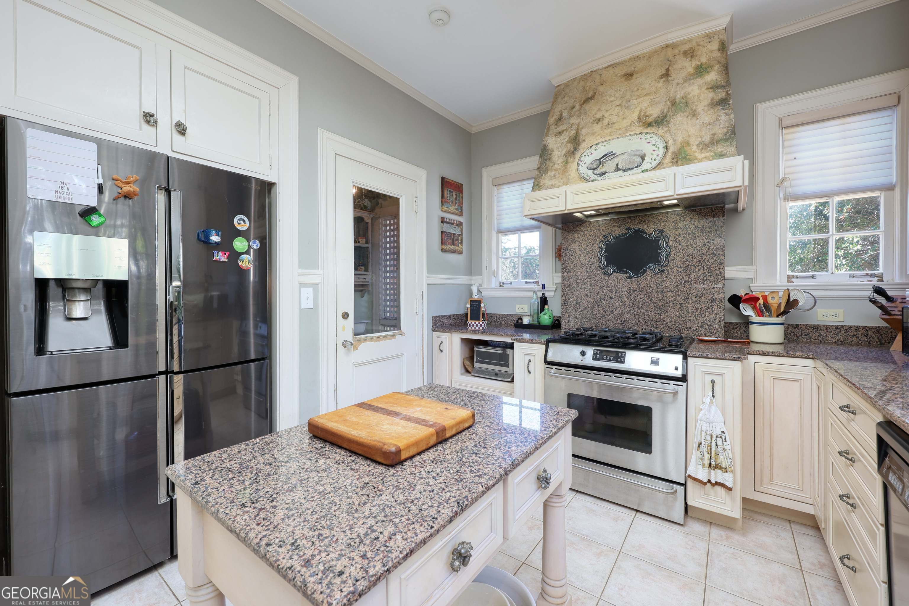 1007 4th Avenue West Point, GA 31833 - Photo 19 of 69 a kitchen with stainless steel appliances granite countertop a refrigerator a stove and white cabinets