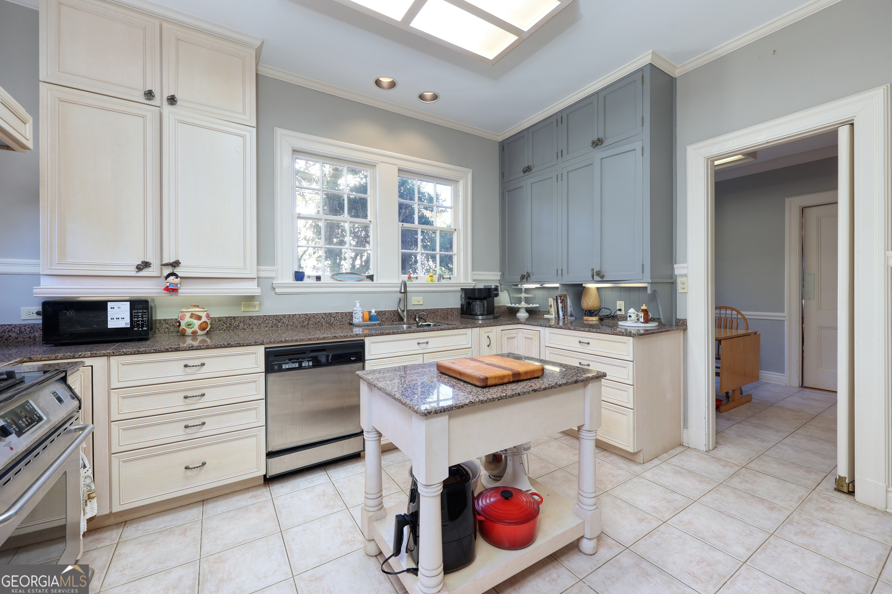 1007 4th Avenue West Point, GA 31833 - Photo 21 of 69 a kitchen with a stove a sink and a refrigerator