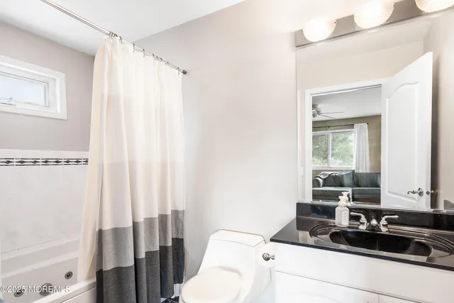 a bedroom with furniture and a window