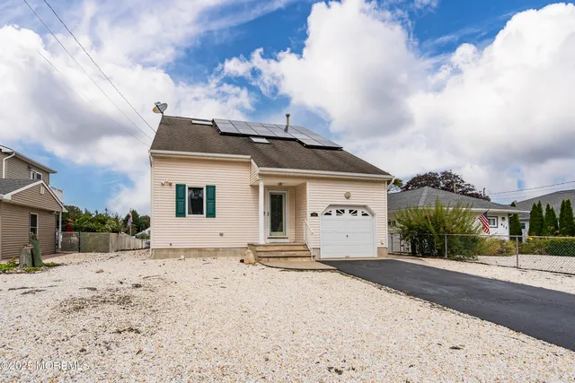 a view of a livingroom with furniture wooden floor and windows