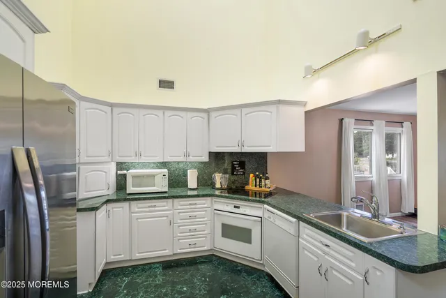 a kitchen with cabinets a sink and a window
