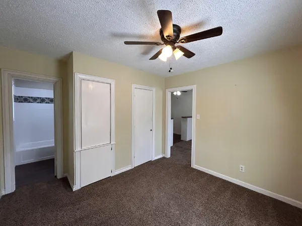 a view of a livingroom with a ceiling fan and entryway