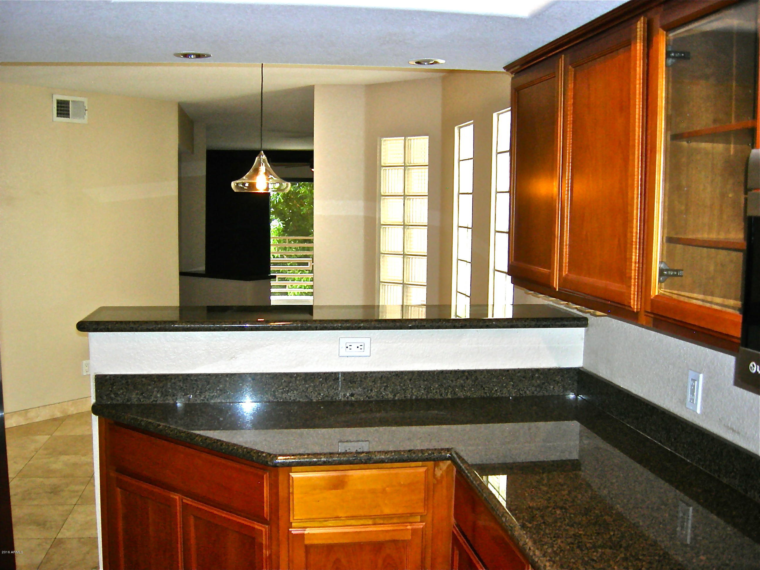 3235 East Camelback Road, Unit 213 Phoenix, AZ 85018 - Photo 21 of 43 View from Kitchen to Living Room