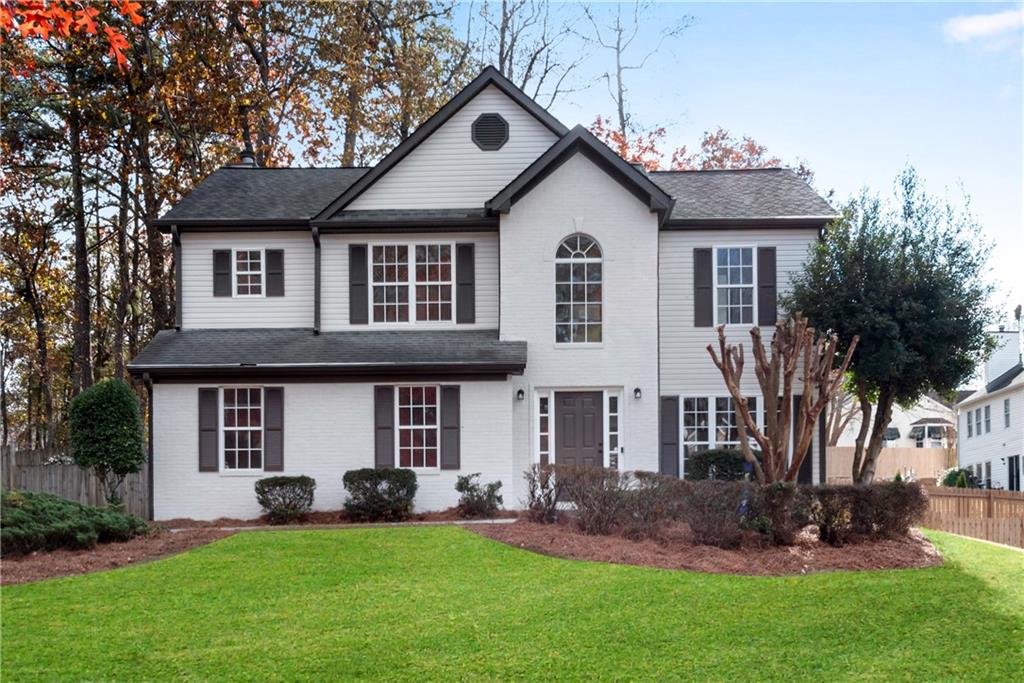 1650 Rushing River Way Suwanee, GA 30024 - Photo 1 of 1 a front view of a house with a yard and porch