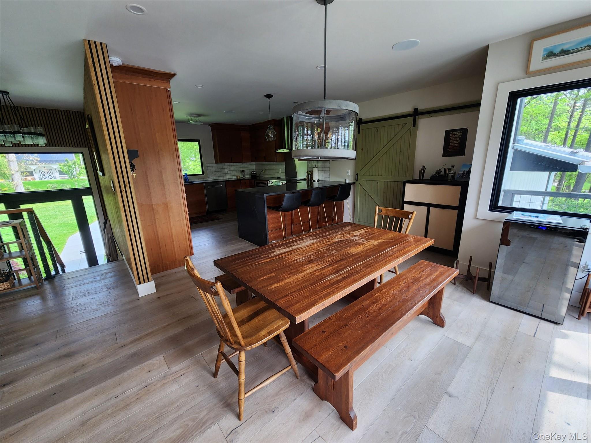 53 Lake Pleasant Road Staatsburg, NY 12580 - Photo 8 of 34 a living room with furniture dining table wooden floor and a fireplace