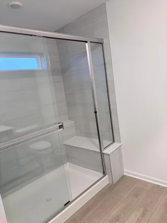 a bathroom with a shower and a bath tub