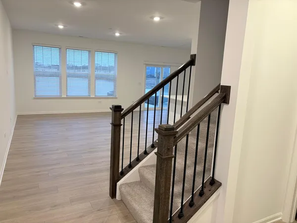 a view of staircase with wooden floor and stairs