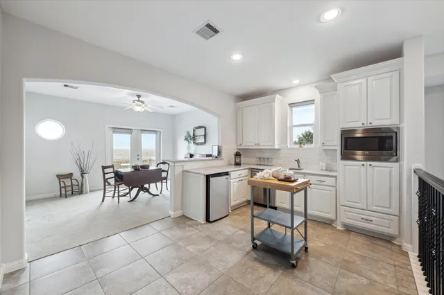 a living room with furniture a dining table and kitchen view