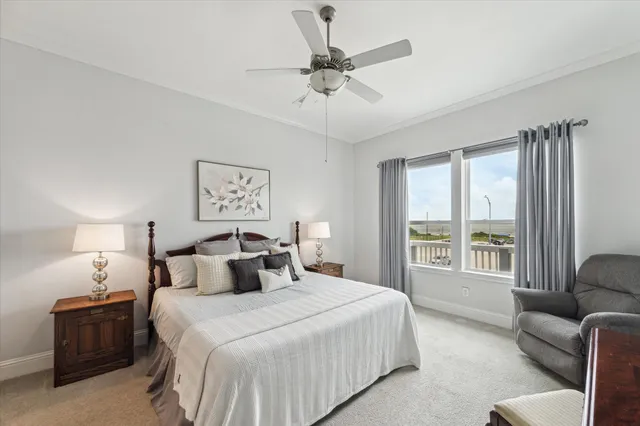 a bedroom with a bed a couch and a large window