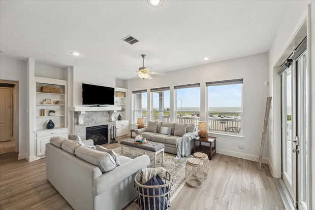 a living room with furniture flat screen tv and a fireplace