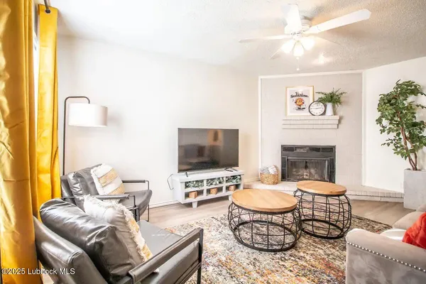 a living room with furniture a fireplace and a flat screen tv