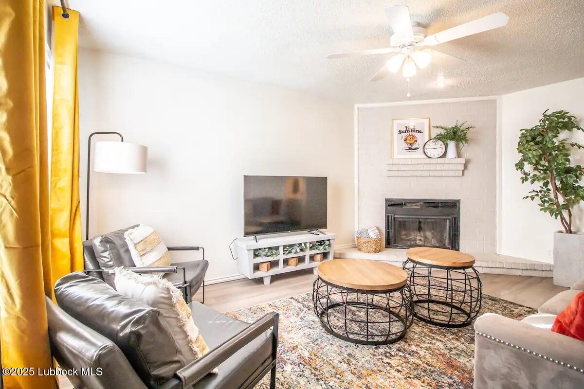 5806 6th Street, Unit B Lubbock, TX 79416 - Photo 1 of 45 a living room with furniture a fireplace and a flat screen tv