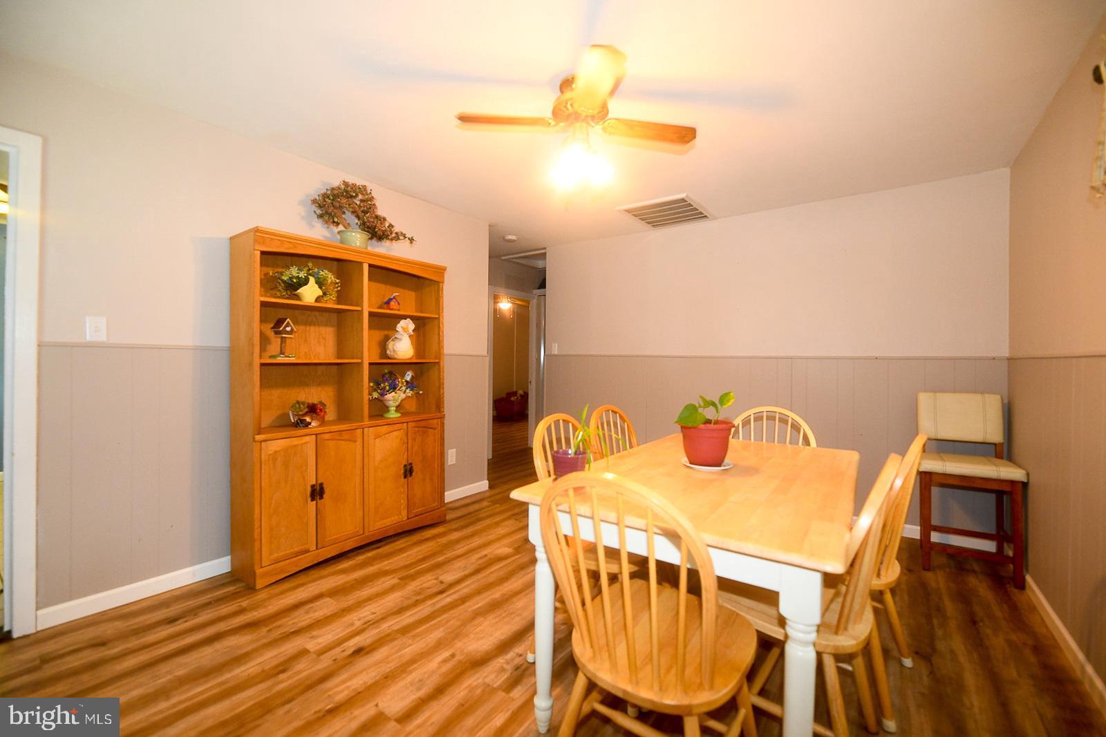 17309 Piney Point Road Piney Point, MD 20674 - Photo 12 of 38 a view of a dining room with furniture and wooden floor