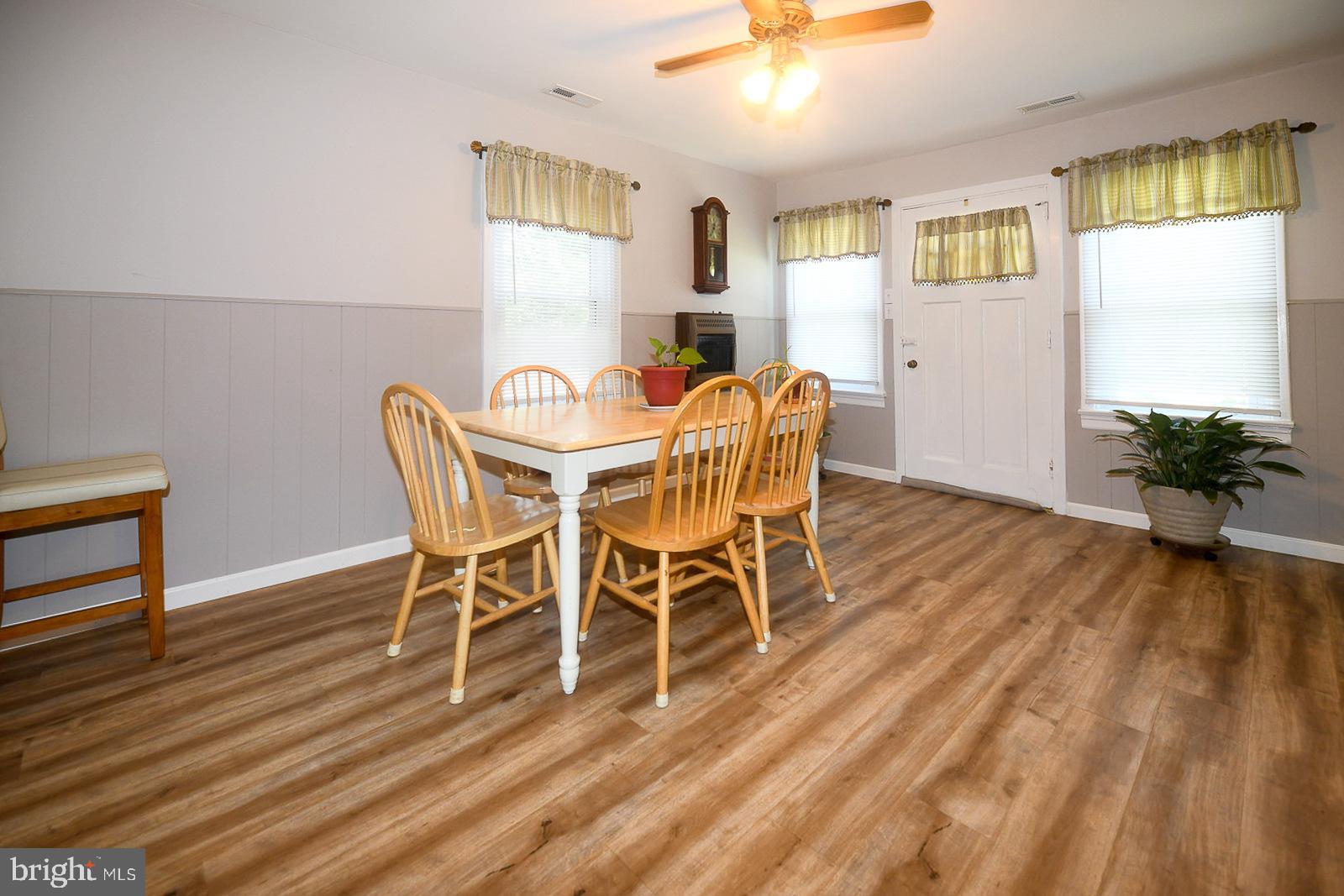 17309 Piney Point Road Piney Point, MD 20674 - Photo 13 of 38 a view of a dining room with furniture and wooden floor