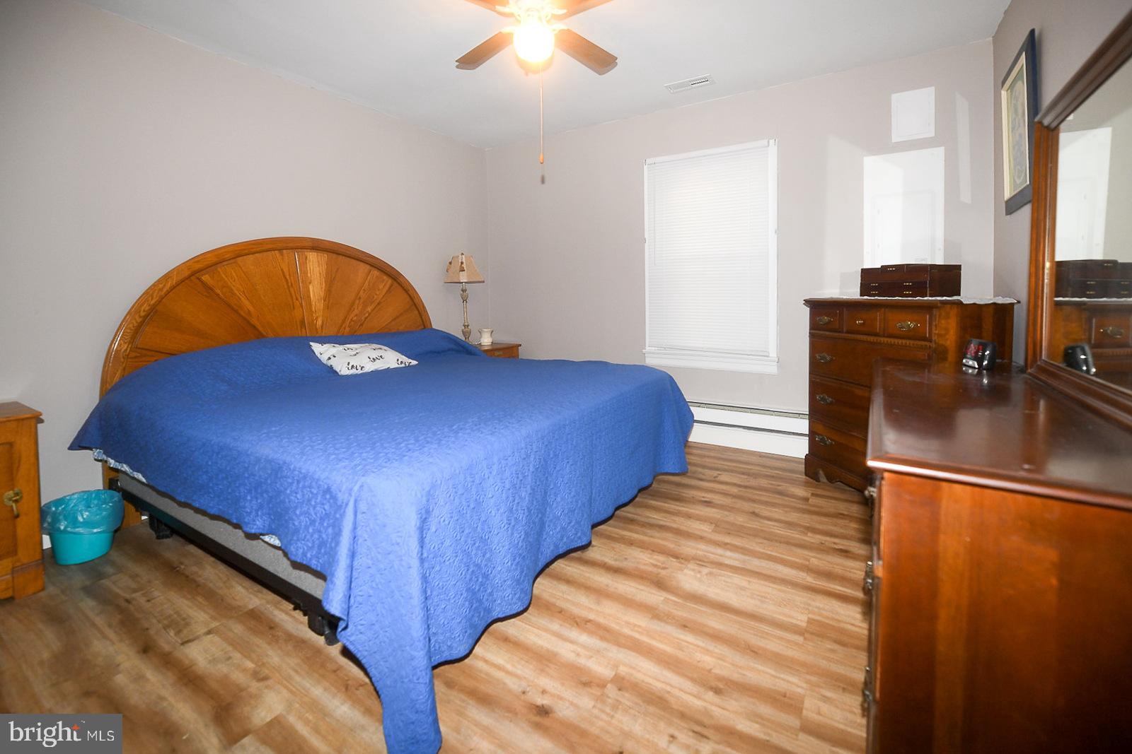 17309 Piney Point Road Piney Point, MD 20674 - Photo 14 of 38 a bedroom with bed and wooden floor