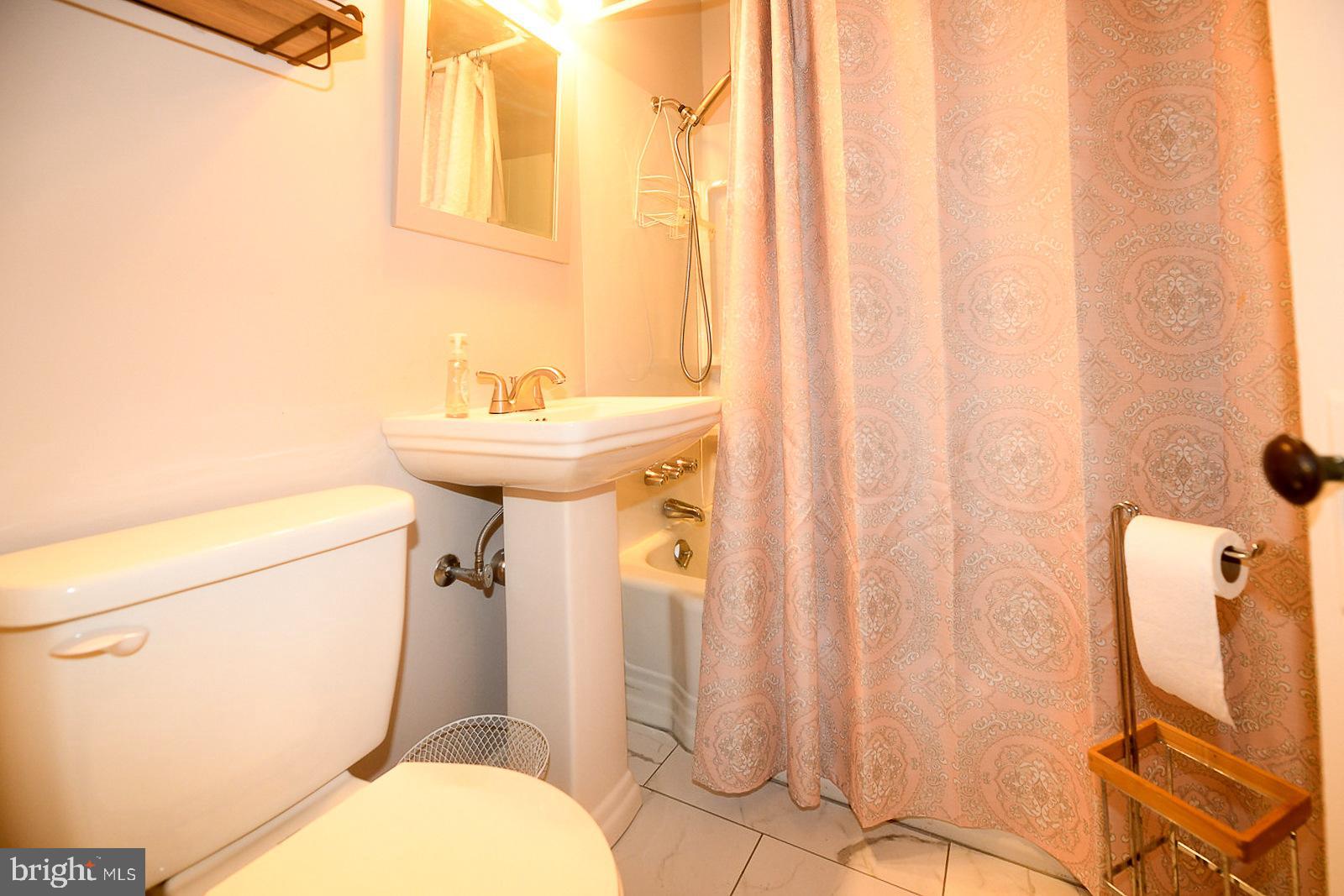 17309 Piney Point Road Piney Point, MD 20674 - Photo 17 of 38 a bathroom with a sink toilet and shower