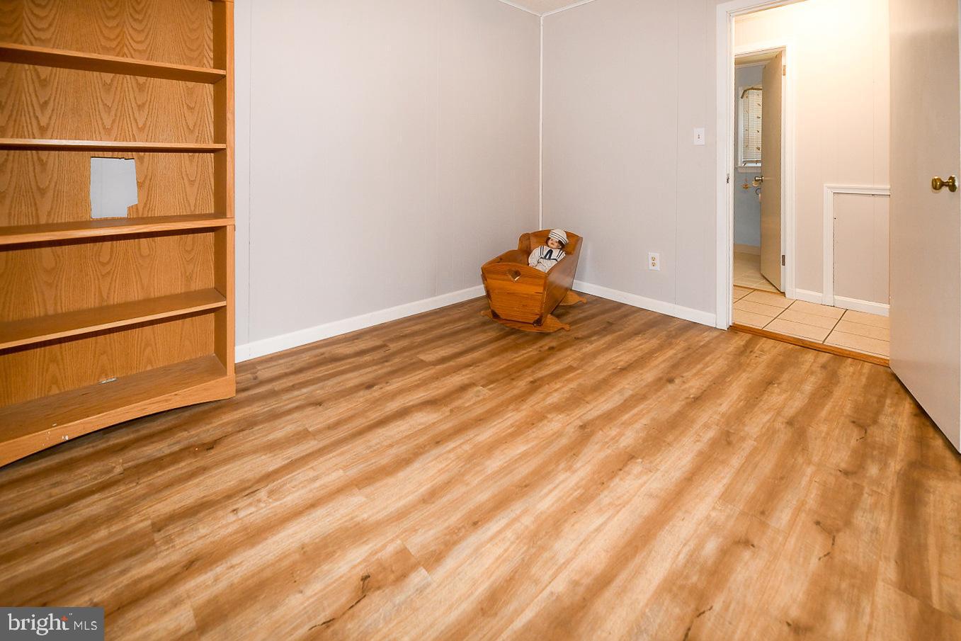 17309 Piney Point Road Piney Point, MD 20674 - Photo 19 of 38 a view of empty room with wooden floor
