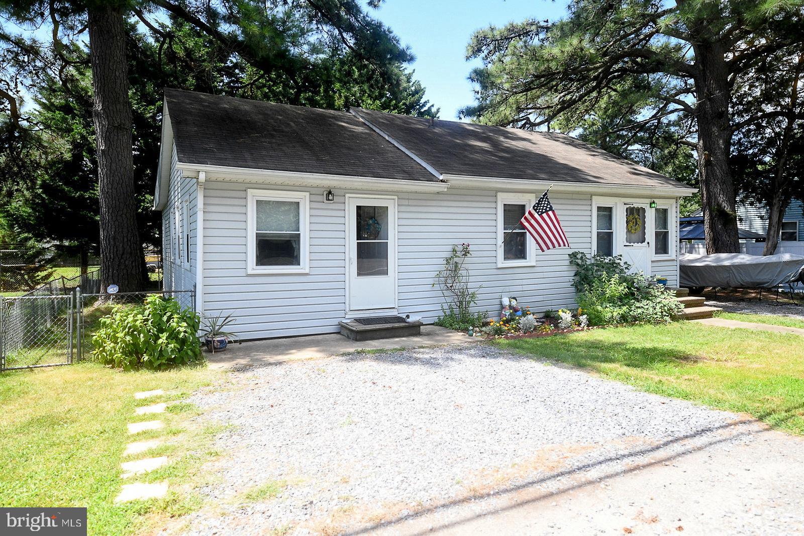 17309 Piney Point Road Piney Point, MD 20674 - Photo 22 of 38 a front view of house with yard and trees around
