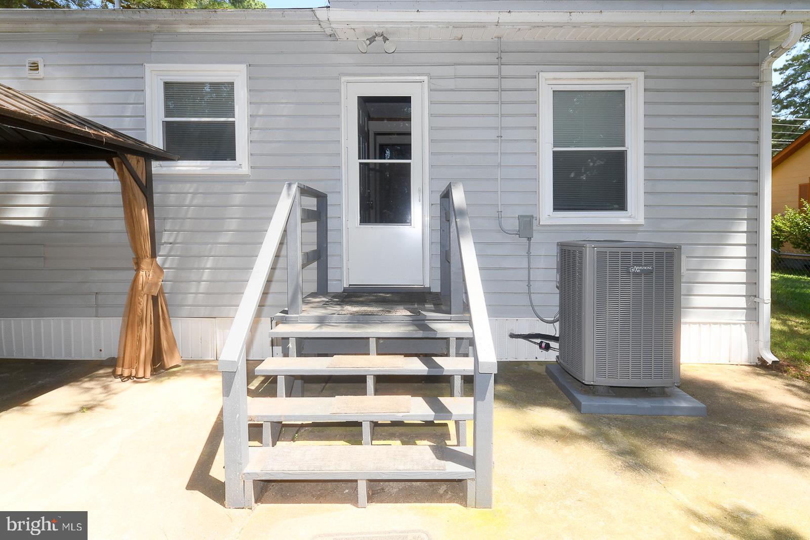 17309 Piney Point Road Piney Point, MD 20674 - Photo 30 of 38 a front view of a house with outdoor seating