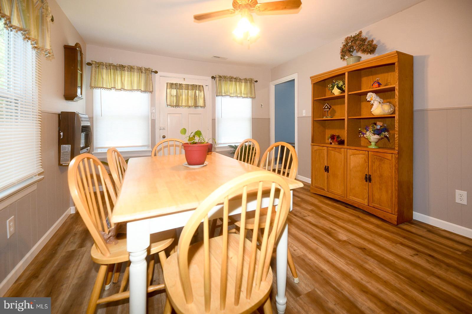 17309 Piney Point Road Piney Point, MD 20674 - Photo 3 of 38 a view of a dining room with furniture window and wooden floor