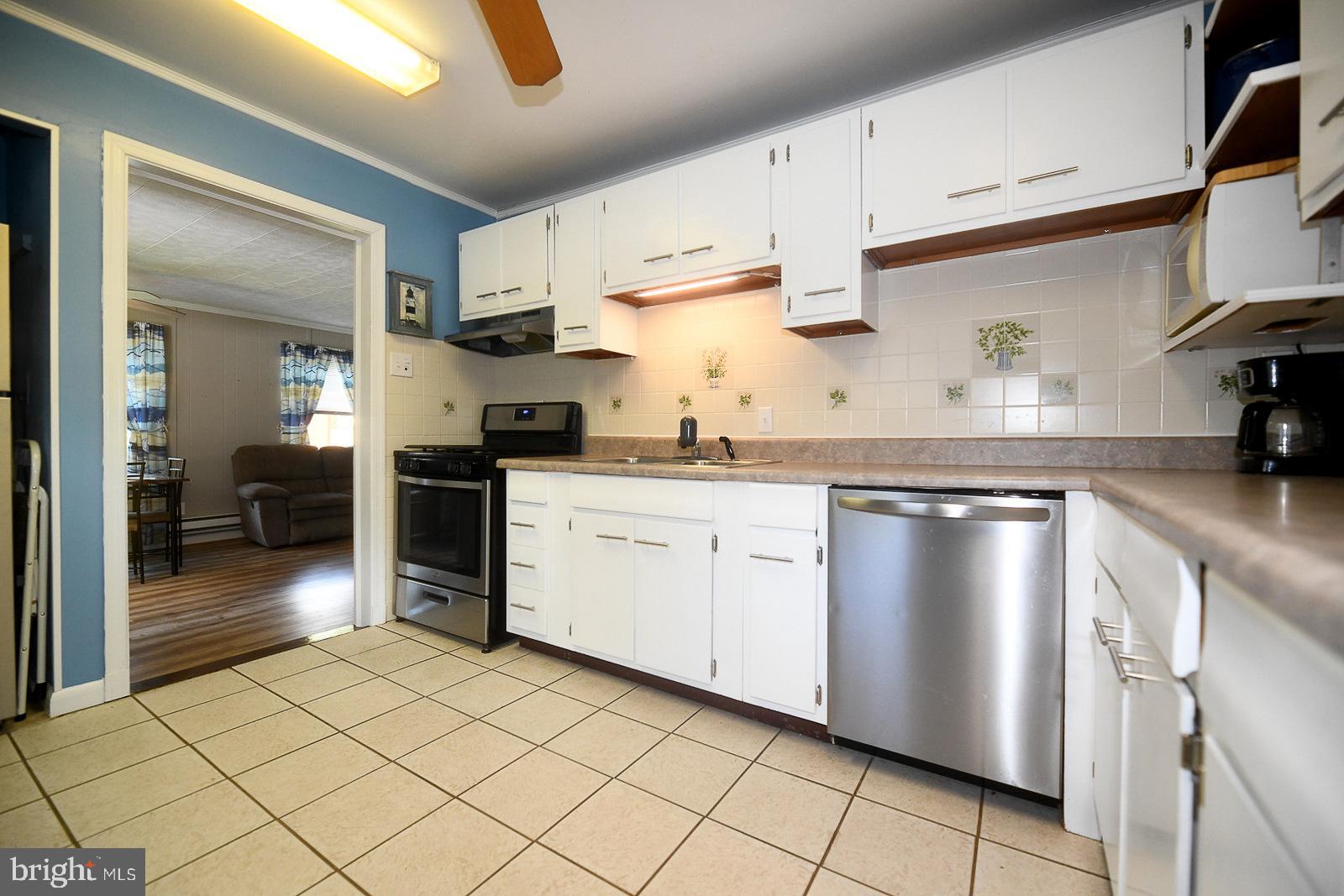 17309 Piney Point Road Piney Point, MD 20674 - Photo 4 of 38 a kitchen with stainless steel appliances granite countertop a sink stove and cabinets