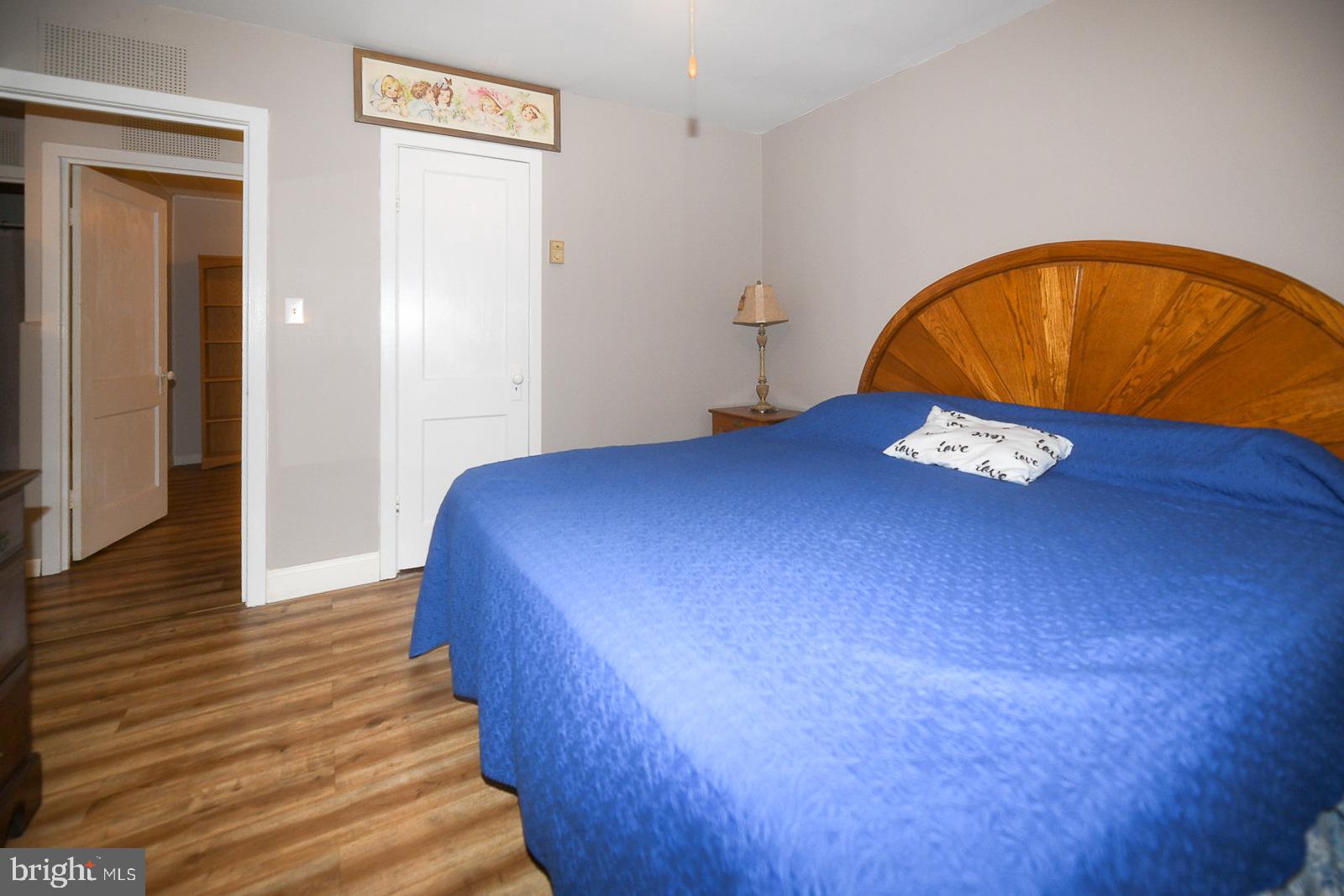 17309 Piney Point Road Piney Point, MD 20674 - Photo 5 of 38 a bedroom with a bed and a painting on the wall