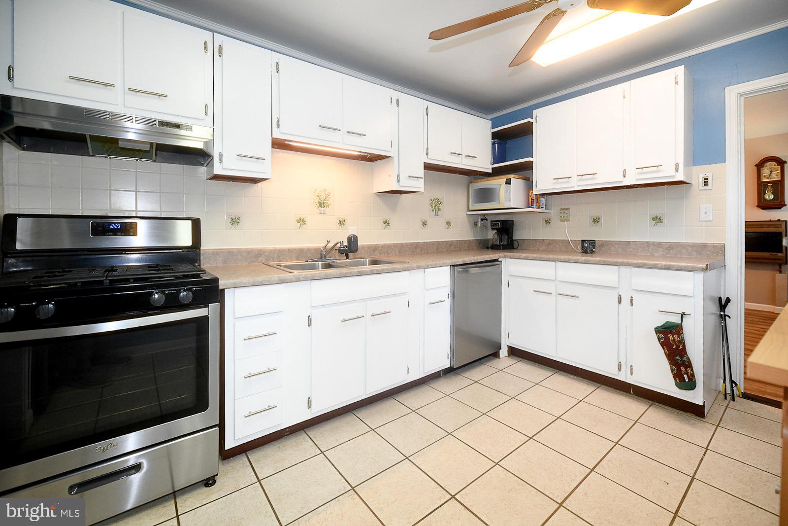 17309 Piney Point Road Piney Point, MD 20674 - Photo 8 of 38 a kitchen with a sink stove and cabinets