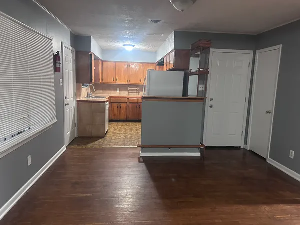 a view of a kitchen with wooden floor