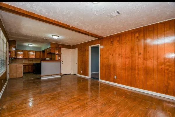 a view of an empty room with kitchen