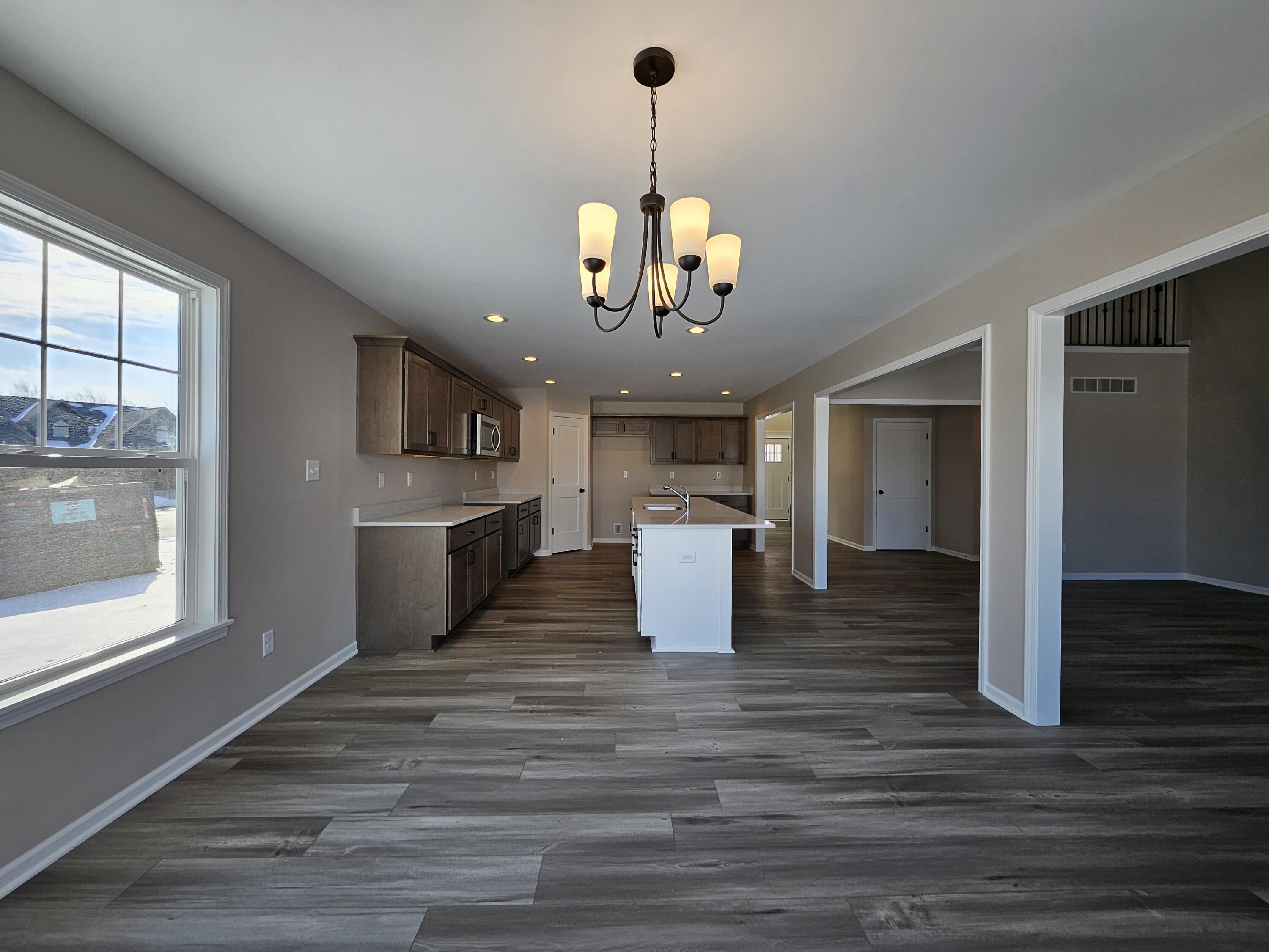 5012 Stephen Lane Lowell, IN 46356 - Photo 13 of 46 a view of a dining room kitchen with a chandelier
