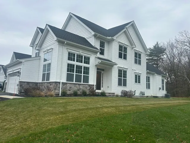 a view of a wooden house with a yard and large trees