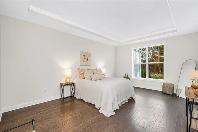 a living room with furniture a rug and a table
