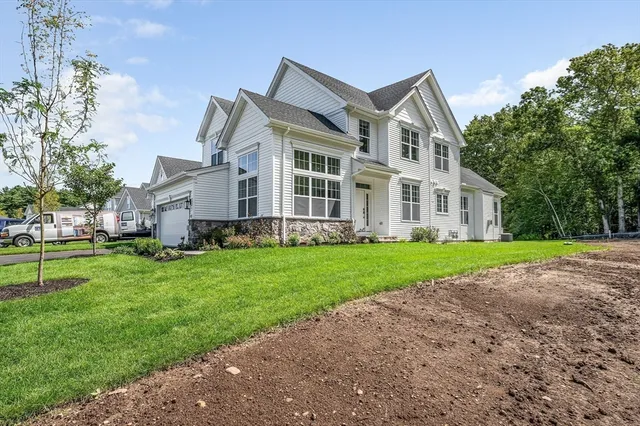 a view of entryway and dining room with wooden floor