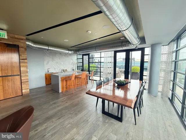 a dining room with furniture and wooden floor