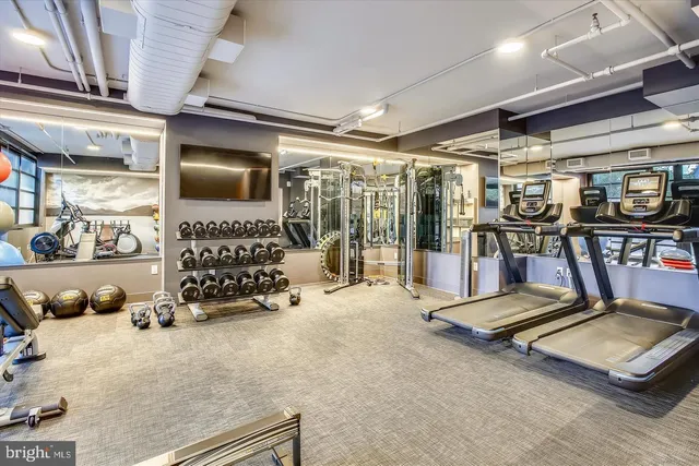 a room with gym equipment and a large window
