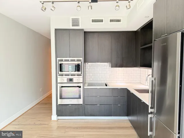 a kitchen with a sink and an oven