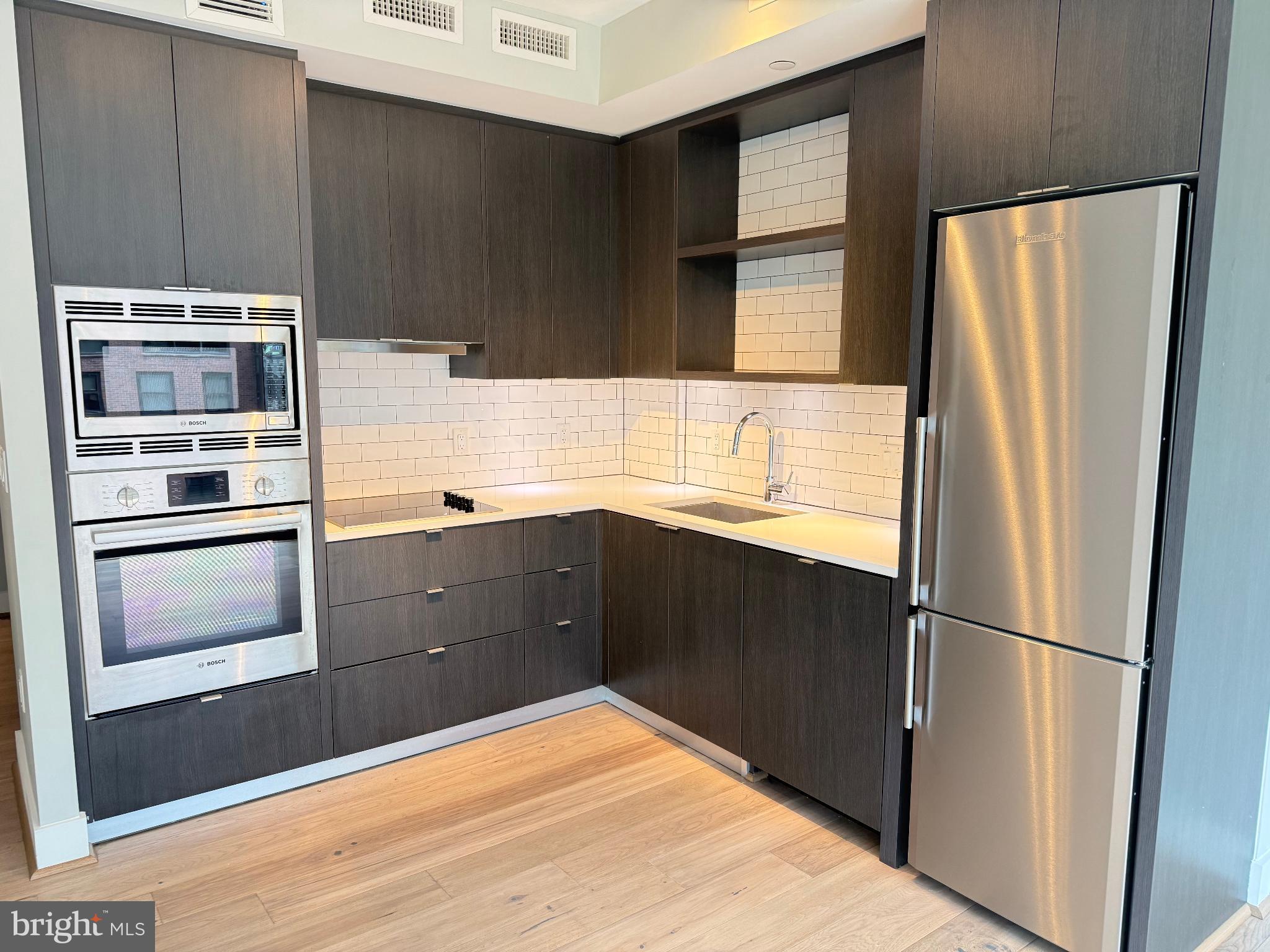 1300 4th Street Southeast, Unit 402 Washington, DC 20003 - Photo 4 of 27 Sleek modern kitchen with elegant finishes.