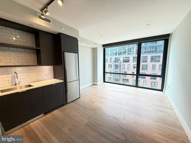 a view of a kitchen with a sink and a refrigerator
