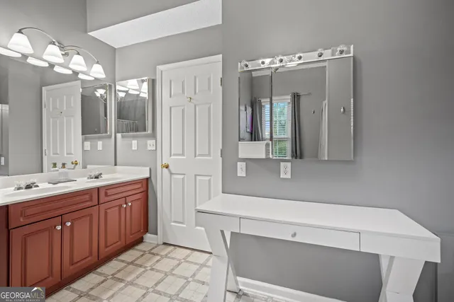 a bathroom with a double vanity sink mirror and double