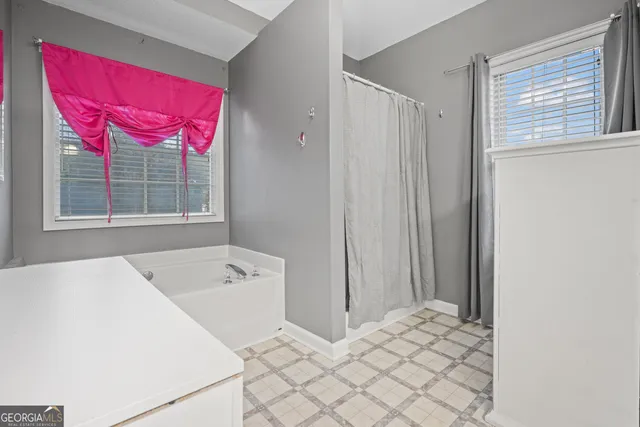 a en suite bathroom with a tub shower and window