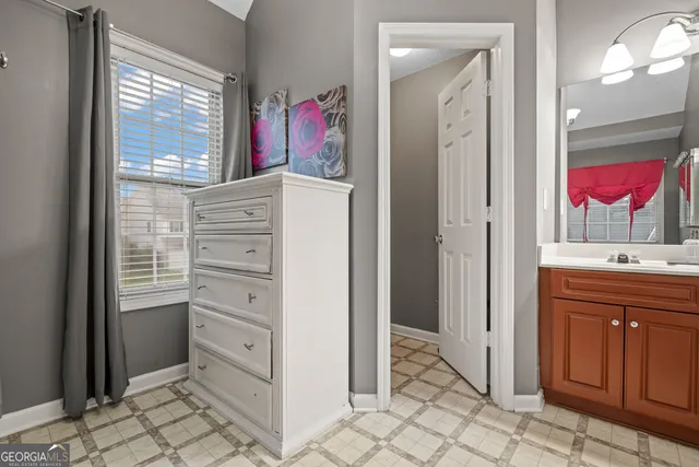 a view of walk in closet with clothes